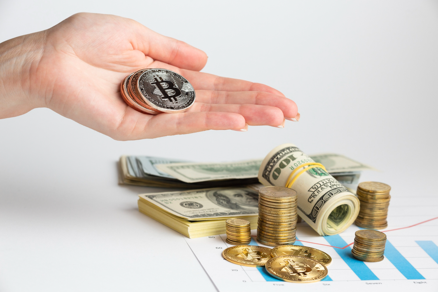 Wealth Management Hand holding cryptocurrency coins over cash and chart